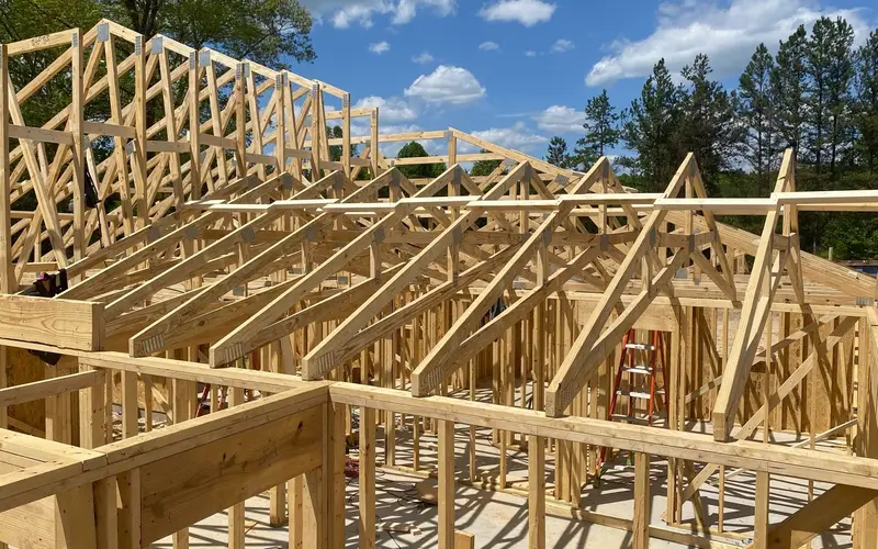 General contractor in Chattanooga, TN: roof trusses set on framed walls of a new home